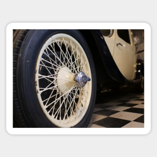 Old spoke wheel of vintage car in cream colour Sticker